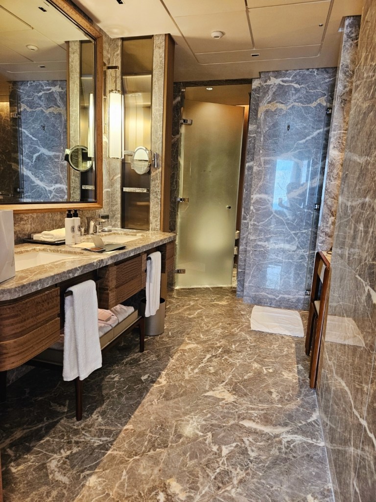 Marble bathroom at SIGNIEL Seoul with bathtub, separate shower, and clean, modern design.