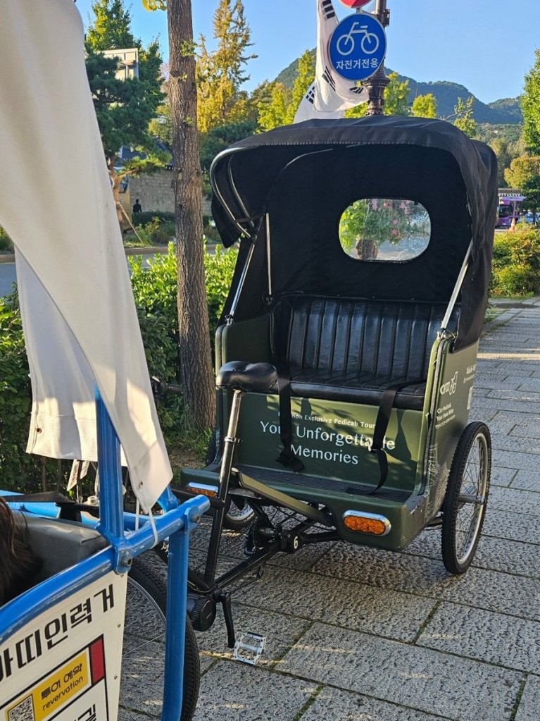 Family riding the Artee rickshaw through Bukchon Hanok Village in Seoul