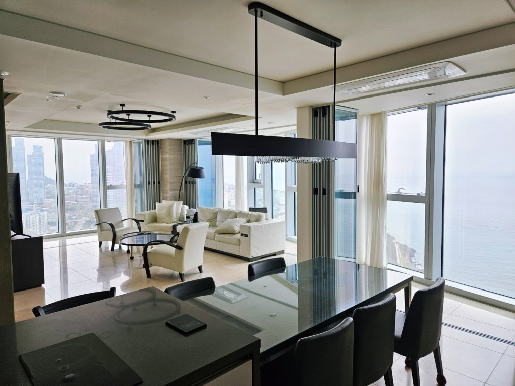 Spacious family-friendly Haeundae LCT residence with ocean view living room, dining area, and full kitchen amenities