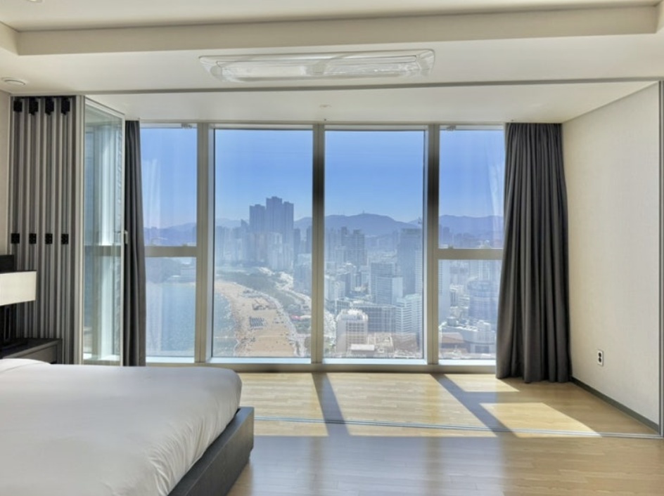 Luxury Haeundae LCT residence bedroom with panoramic ocean and city skyline view in Busan