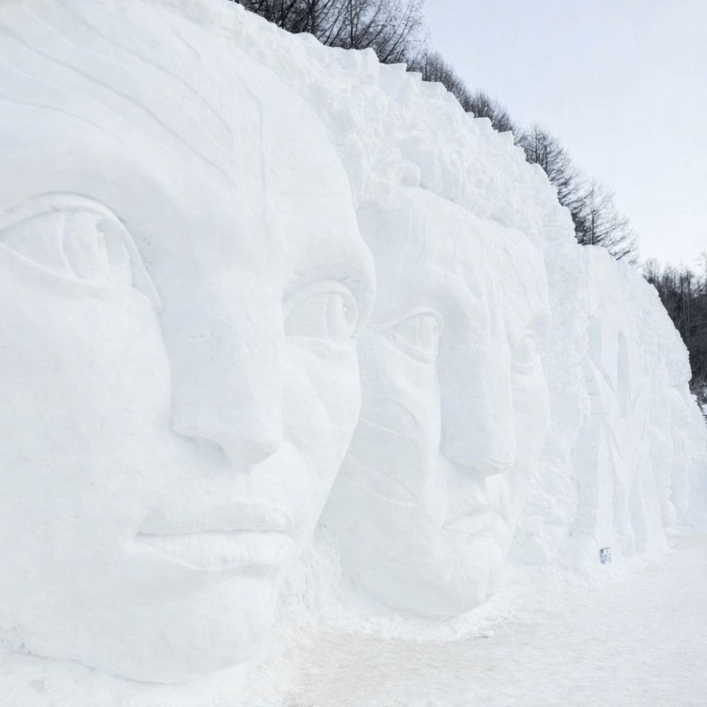 Large-scale snow sculptures at the Taebaeksan Snow Festival in Taebaek, South Korea, carved into massive white snow walls during winter