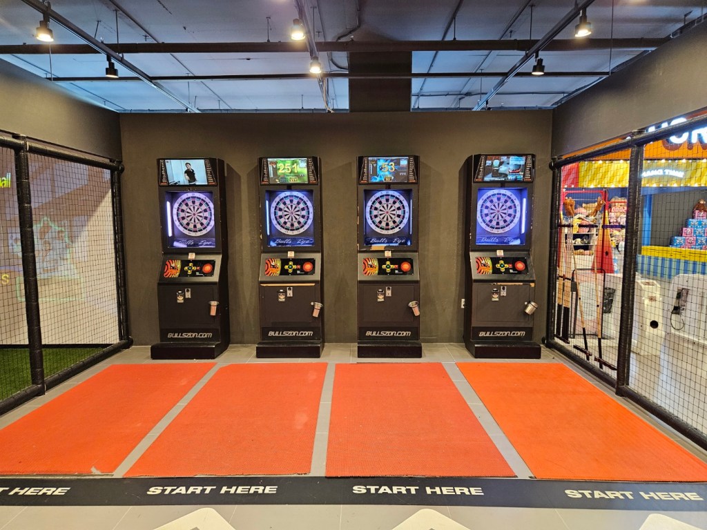 Electronic dart machines inside the arcade zone at Wonderspace Gyeongju, a popular indoor activity for teens and families.