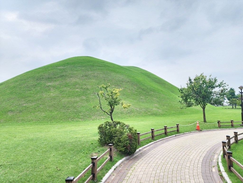 Cheonmachong burial mound inside the Daereungwon Tomb Complex in Gyeongju, a peaceful green landmark easily visited during a scooter ride.