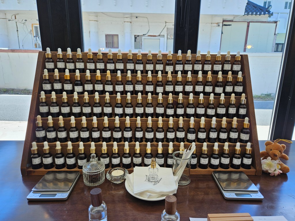 A neatly arranged display of fragrance bottles and tools inside a perfume workshop in Seoul, used for creating personalized perfumes.