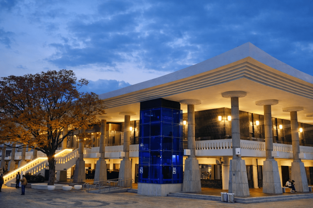 National Gyeongju Museum exterior at dusk, showing the calm evening atmosphere and modern architecture surrounded by trees