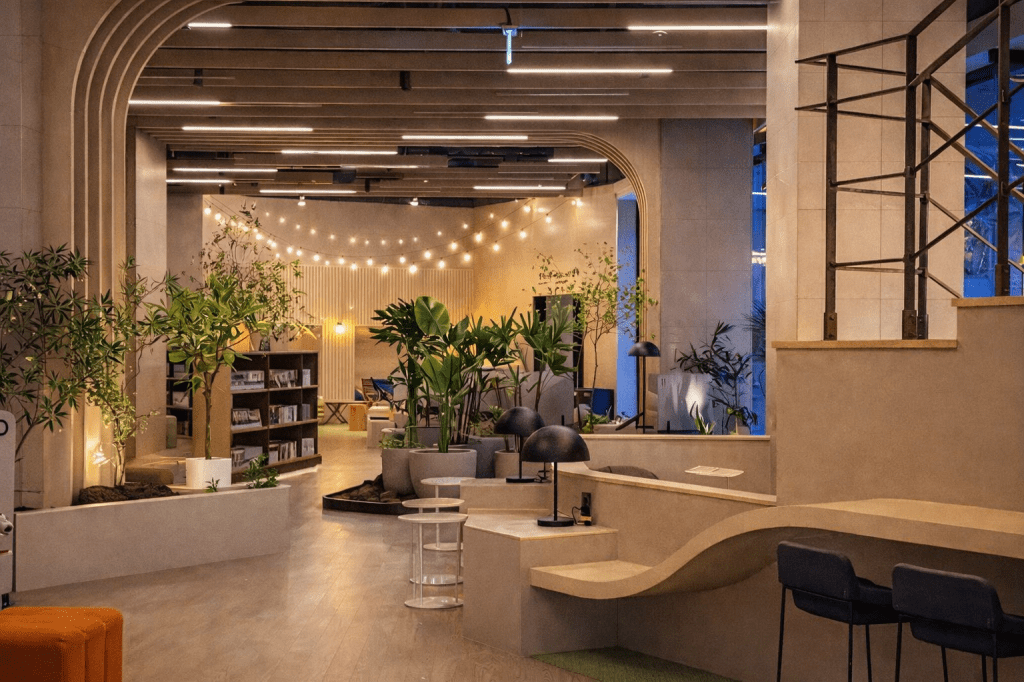Modern 24-hour jjimjilbang near Seoul featuring a stylish lounge area with plants and warm lighting at Spadium 24 in Namyangju