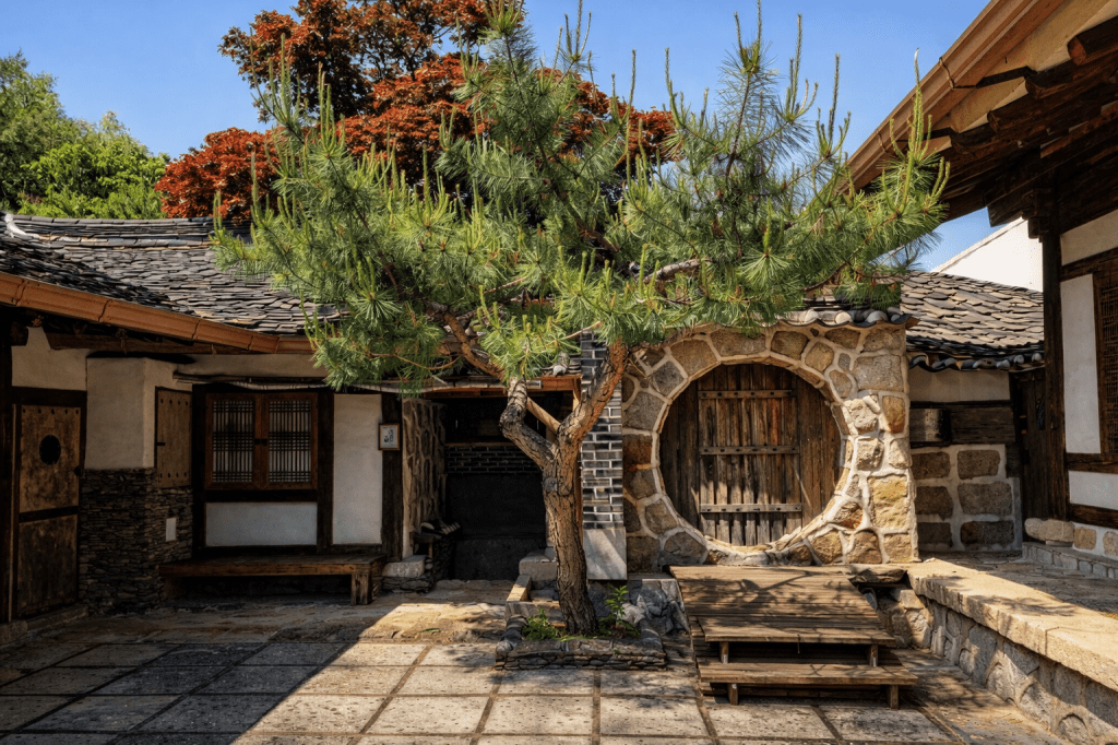 Traditional Korean steam sauna courtyard with wooden architecture and pine tree at Namu Hyanggi Hanjeungmak in Chuncheon