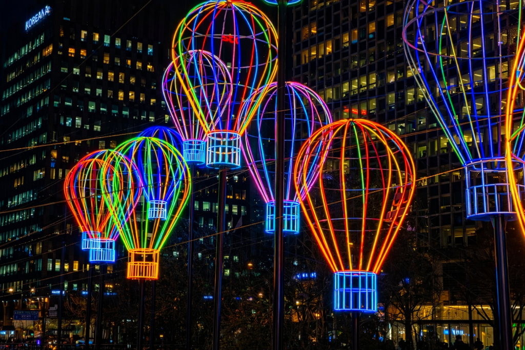 Seoul Lantern Festival at Cheonggyecheon Stream at night, colorful lantern installations reflecting on the water